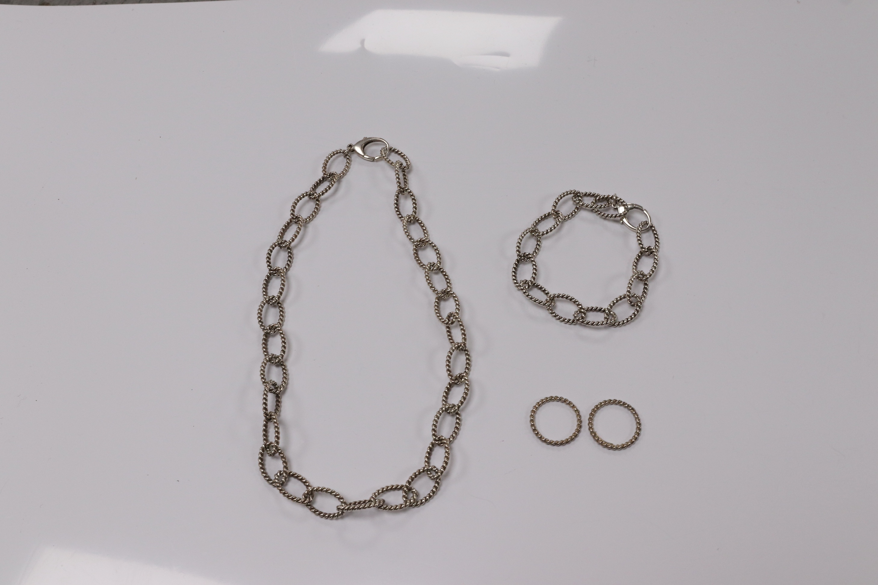 A modern Italian Tiffany & Co 925 suite of jewellery, of rope twist design, comprising a necklace, 42cm, bracelet, 18cm and two rings, size O/P and O. Condition - fair to good